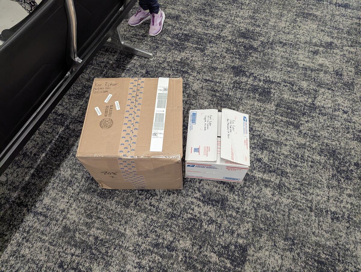 Carry-on and checked boxes with gear in DEN